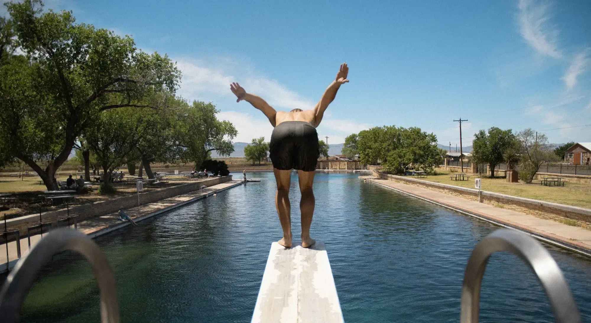 Guy jumping in the swimming pool