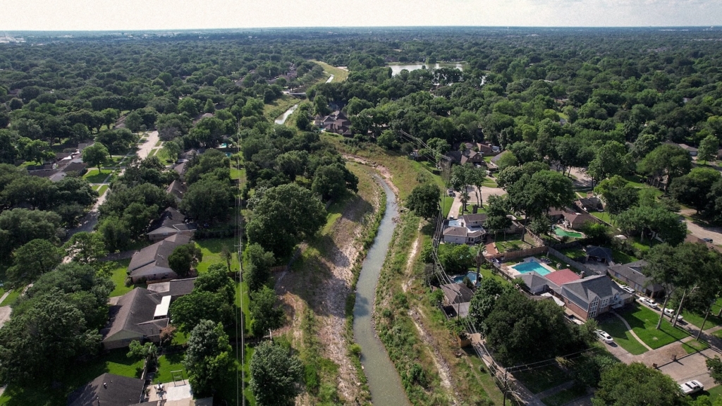 Jersey Village Neighborhood Aerial View River Landscape Aerial view of suburban neighborhood with trees and a winding creek in Jersey Village, TX